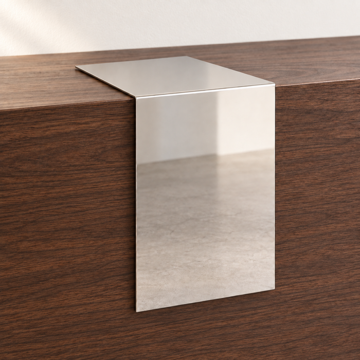 Mirrored stainless steel waterfall tabletop sign draped over the edge of a wooden counter.