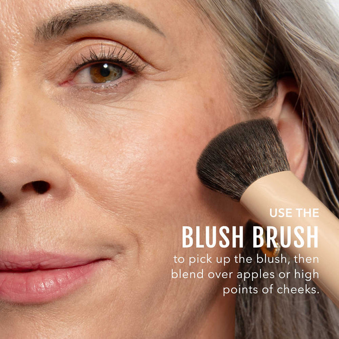 No Makeup Makeup – Woman applying plum blush & lip color with a brush, close-up of face, natural minimal makeup