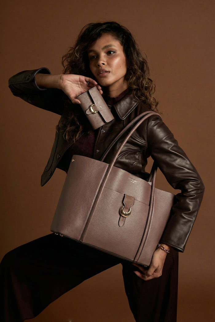 Female model wearing Lilibet Fawn faux leather Laptop Tote over her shoulder using the shoulder straps and holding matching Letitia Fawn Medium Purse