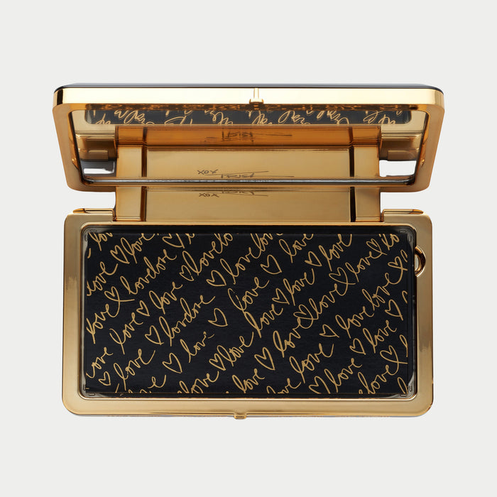 Gold and black clutch with 'I love you' text on a light gray background