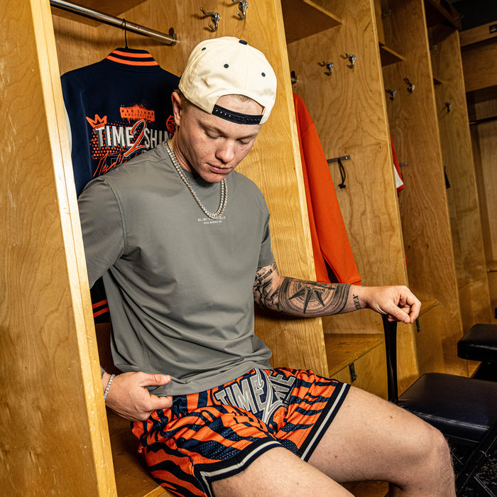 Adult model wearing orange Max Clark Tiger Court shorts