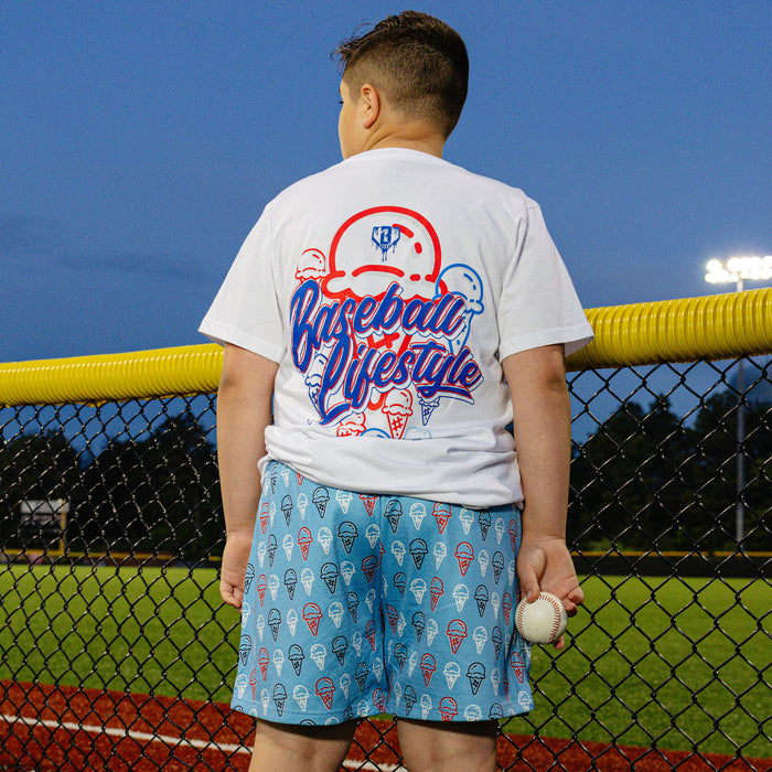 Youth model wearing red, white & blue Scoops Ice Cream Light Blue youth shorts