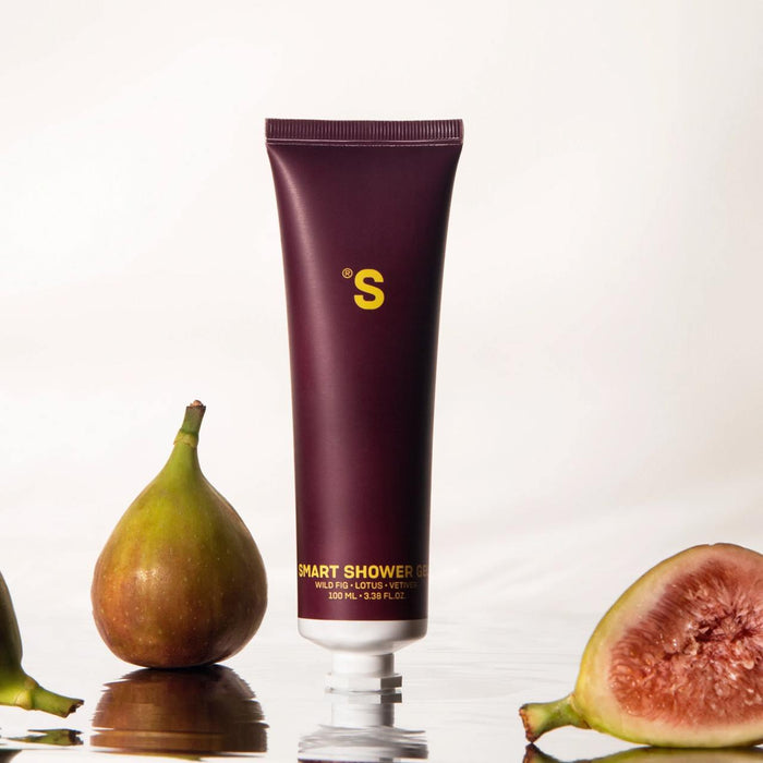Sister's Aroma shower gel fig product with figs on a reflective surface