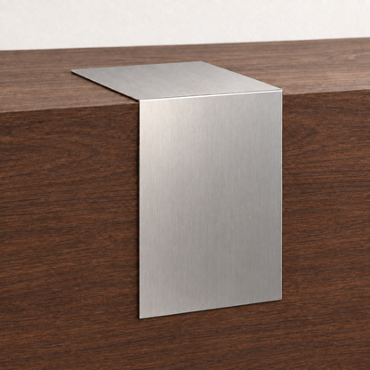 Brushed stainless steel waterfall tabletop sign draped over the edge of a wooden counter.