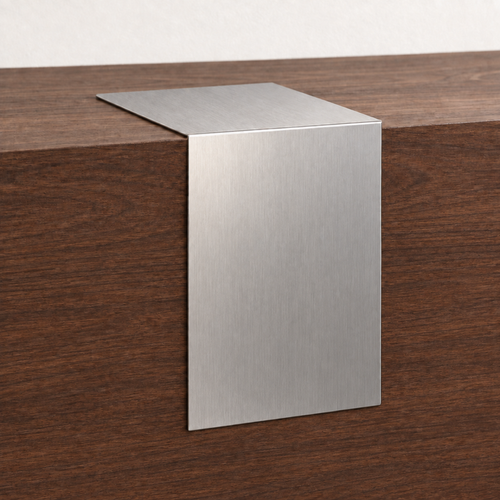 Brushed stainless steel waterfall tabletop sign draped over the edge of a wooden counter.