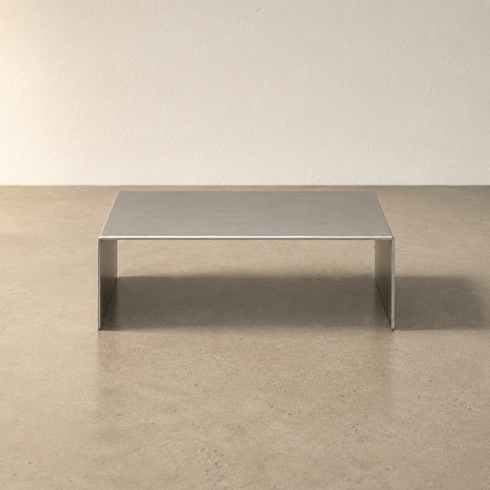 Front view of a wide stainless steel display riser.