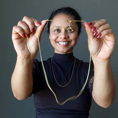 holding sheila of satin crystals wearing Adjustable Snake 14 Karat Gold on Sterling Silver chain