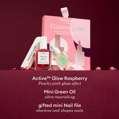 The Manucurist 5min' Glow Manicure set comes in a pink "Gimme glow" box with Active™ Glow Raspberry polish, Mini Green cuticle oil, mini nail file, and decorative pearls—ideal for pampering or gifting as a festive ornament.