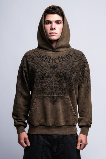 A young man faces forward against a plain light-gray background, wearing the 686 Affliction Natural Rot Pullover Hoody by 686, a brown men‚Äôs sweatshirt featuring black intricate designs and "Affliction" on the chest.