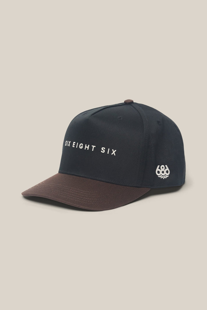 Introducing the 686 High-Pro Ses Two Tone Structured 5 Panel Hat by 686—a stylish men's hat in black and brown cotton, featuring "SIX EIGHT SIX" embroidered on the front and a small 686 logo on the side, displayed against a light background.