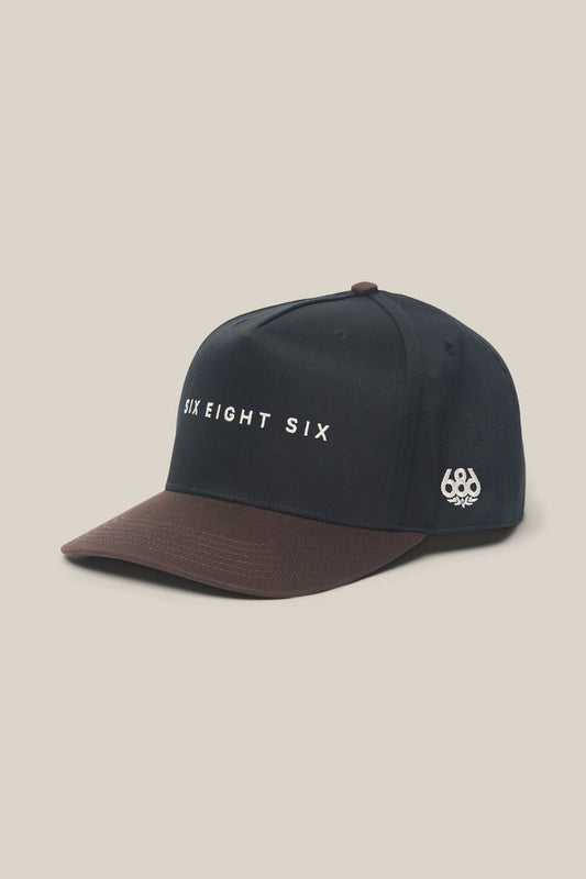 Introducing the 686 High-Pro Ses Two Tone Structured 5 Panel Hat by 686—a stylish men's hat in black and brown cotton, featuring "SIX EIGHT SIX" embroidered on the front and a small 686 logo on the side, displayed against a light background.