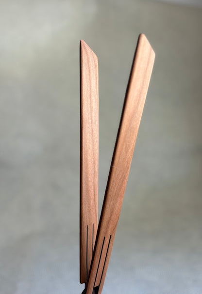 wooden inside out tongs for cooking on light neutral background. Jonathan's Spoons.