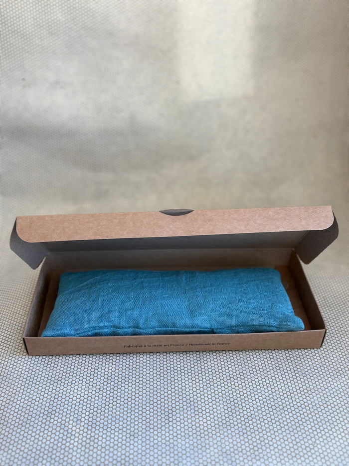 blue eye pillow in a brown cardboard box