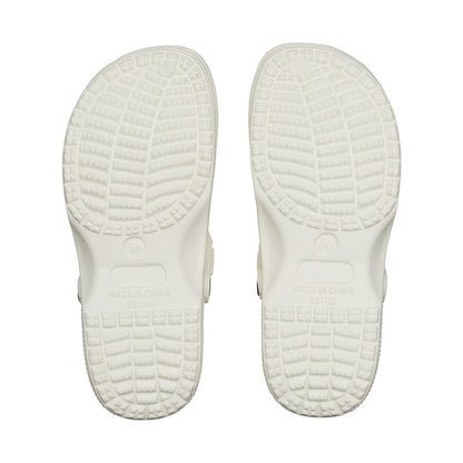 Pair of white air clog shoes shown from bottom view with textured slip resistant tread and molded sole