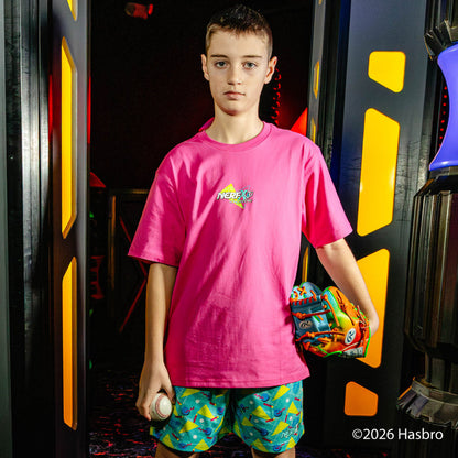 Child wearing a pink 'NERF X BL101' shirt holding a colorful baseball glove in front of a gaming console.