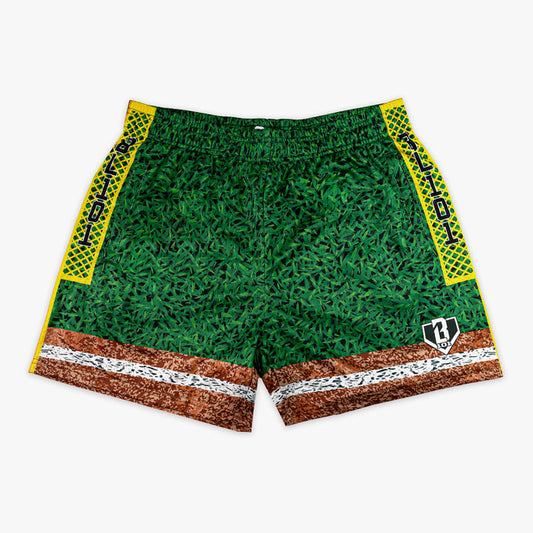 Front flat lay of BL101 baseball field mesh shorts featuring a grass-texture body, dirt and chalk line hem, yellow diamond-pattern side panels with BL101 text, and BL101 logo on a white background.