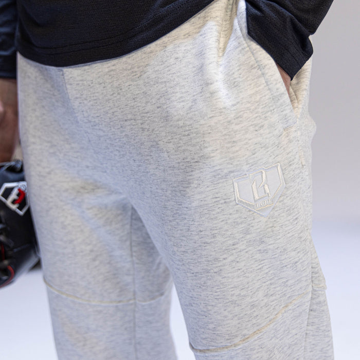 Close-up of gray jogger pants with a BL101 logo on a white background