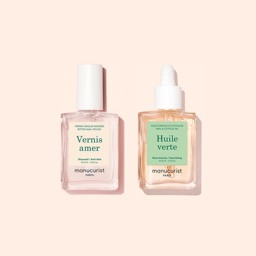 Two square bottles of Manucurist Basic Routine - Bitten Nails products—a renowned nail care duo—one with a white cap and the other with a dropper lid, set against a pale pink background.