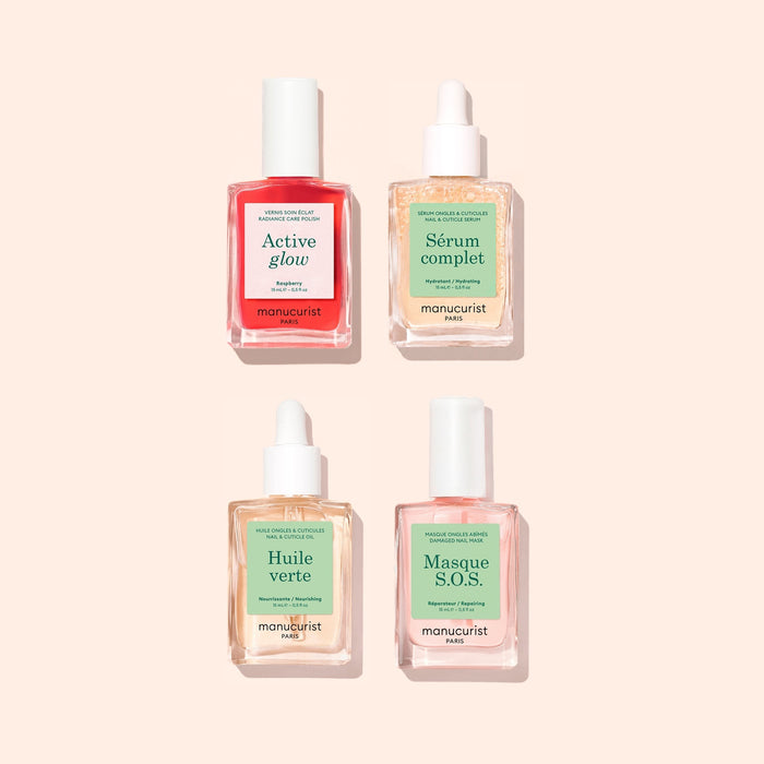Four manicure product bottles from Manucurist's Basic Routine - Sensitive Nails collection, featuring colored labels, are arranged in a grid on a light beige background. Designed for optimal nail care, this set includes Active Glow, Sérum Complet, Huile Verte, and Masque S.O.S.—perfect for moisturizing sensitive nails or giving them a complete rescue treatment.