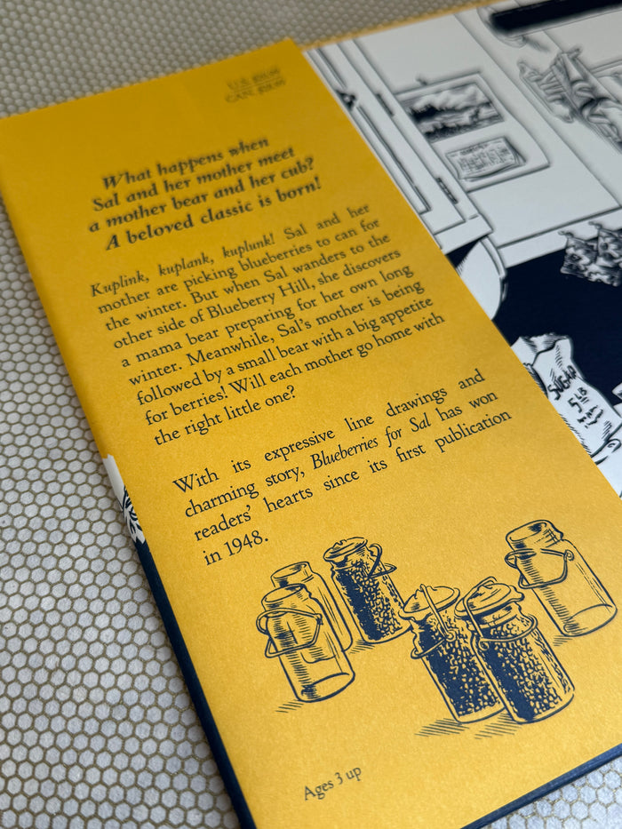 Book with yellow cover featuring black illustrations and text