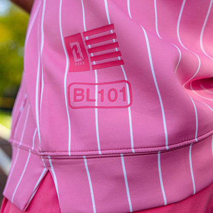 Close-up of the side hem detail on the youth pink pinstripe BSBL-SZN Short Sleeve Hoodie V3 showing the BL101 flag badge and "BL101" label graphic