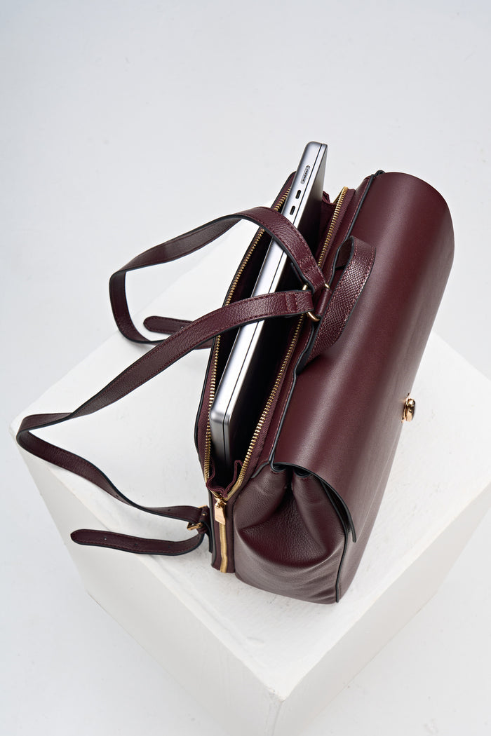 Overead view of Casey Black Cherry faux leather Laptop Backpack showing the back laptop pocket, shoulder straps and reptile printed grab handle