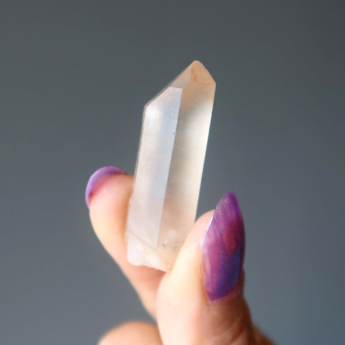 hand holding untreated citrine point