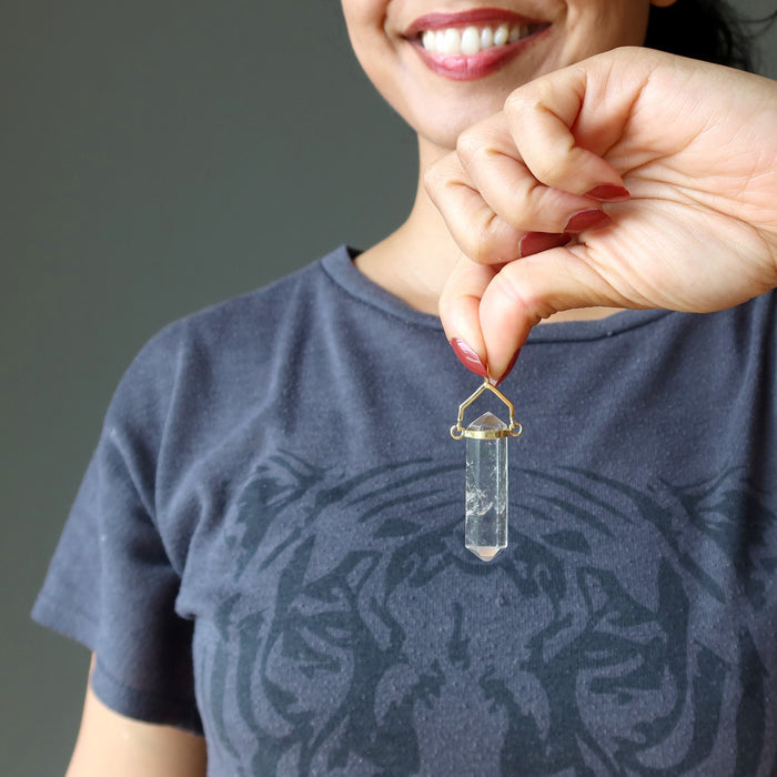 hand holding clear quartz double terminated pendant