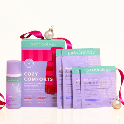 Cozy Comforts soothing skincare kit box with its calming micro mist, barrier-boosting sheet masks, and soothing eye gels, plus pink ribbon and ornaments