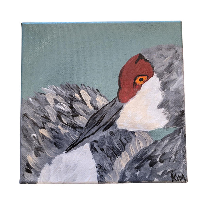 Painting of a bird with a red head and gray body on a textured background