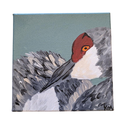 Painting of a bird with a red head and gray body on a textured background