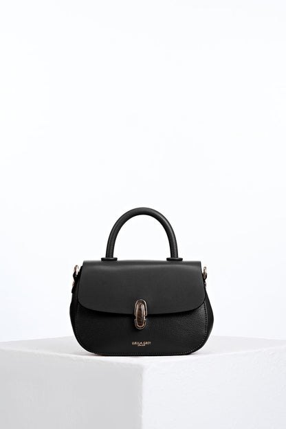 Front of Delia Black faux leather Top Handle Crossbody without detatchable crossbody strap showing resin Waterloo twist lock clasp closure detail