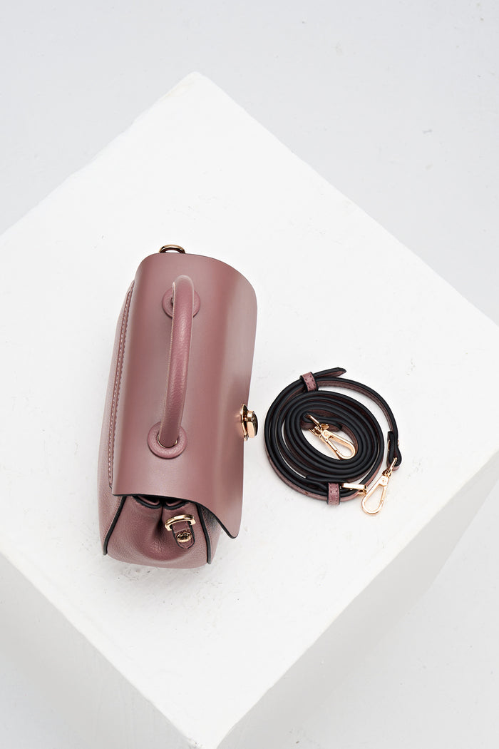 Overhead view of Delia Pecan faux leather Top Handle Crossbody showing the top grab handle and the detachable crossbody strap rolled up beside the bag