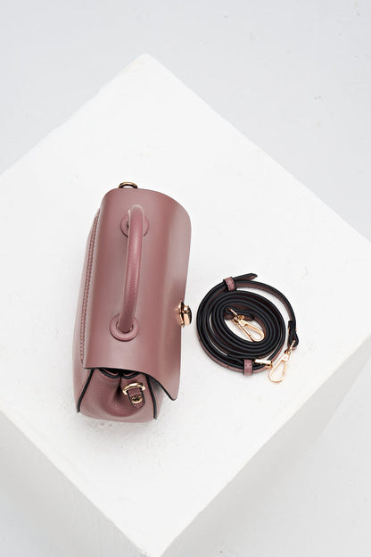 Overhead view of Delia Pecan faux leather Top Handle Crossbody showing the top grab handle and the detachable crossbody strap rolled up beside the bag