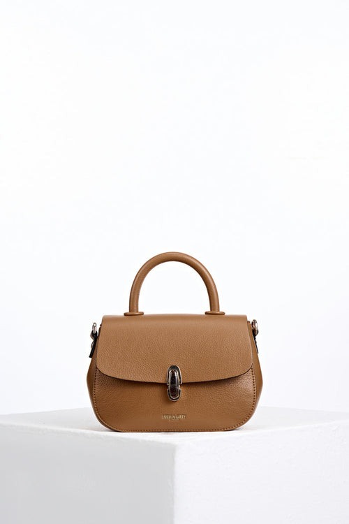 Front of Delia Tan faux leather Top Handle Crossbody without detatchable crossbody strap showing resin Waterloo twist lock clasp closure detail
