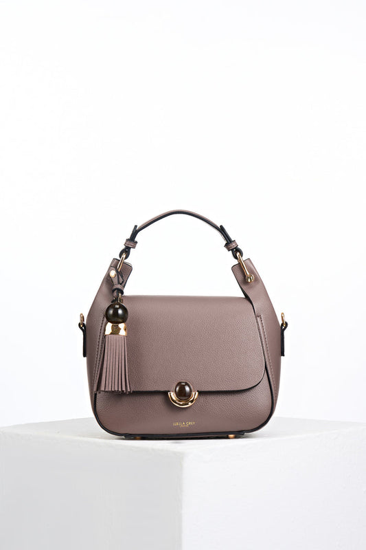 Front view of Diana Fawn faux leather Top Handle Crossbody with gold and resin Thames Tassel and Signature Crystal Palace Clasp closure detail