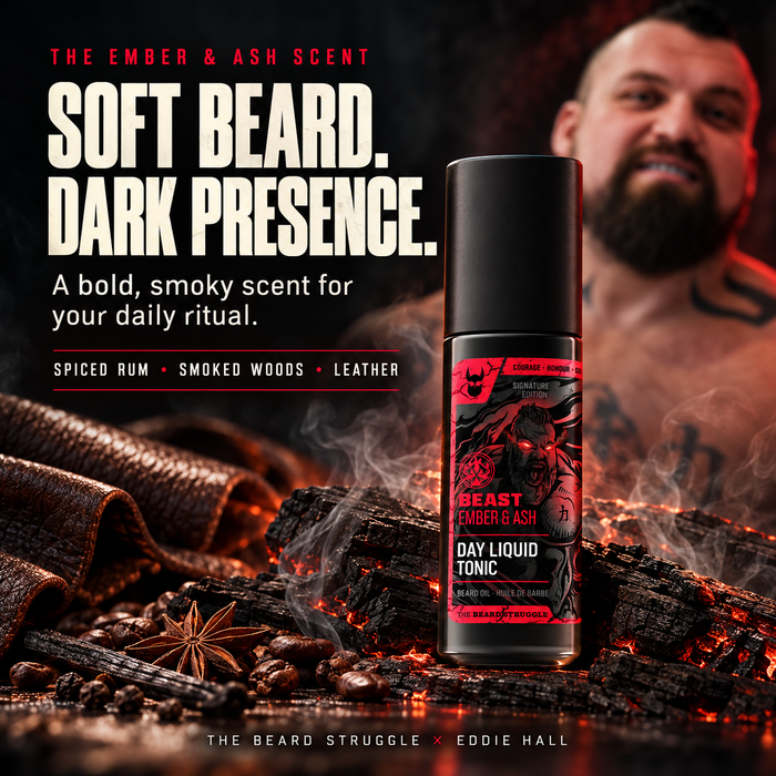 Eddie Hall smiling behind a bottle of Beast Ember & Ash Day Liquid Tonic beard oil, scent notes spiced rum, smoked woods and leather