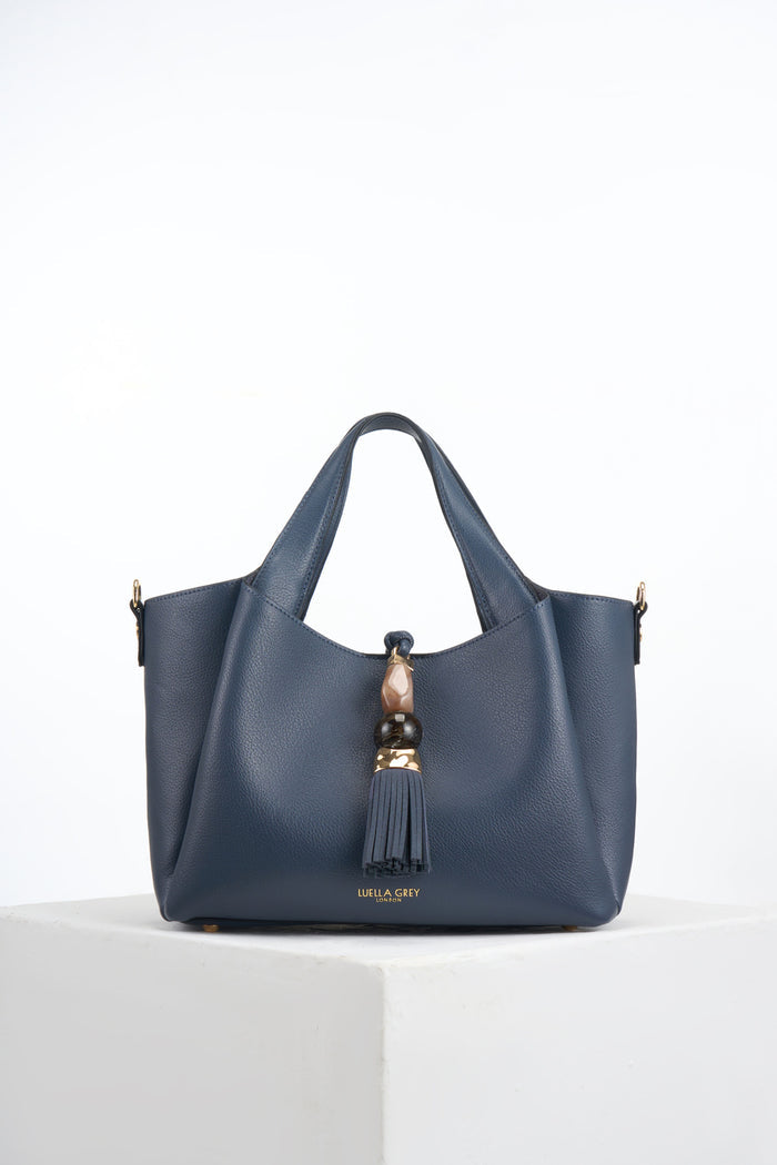 Front of Etta Denim Blue faux leather Small Tote with resin and molten gold Signature Mayfair Tassel charm closure