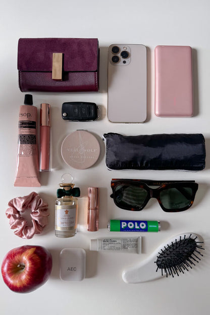Collection of personal items including a purse, phone, beauty products, and accessories to show what would fit in the Etta Fawn faux leather Small Tote