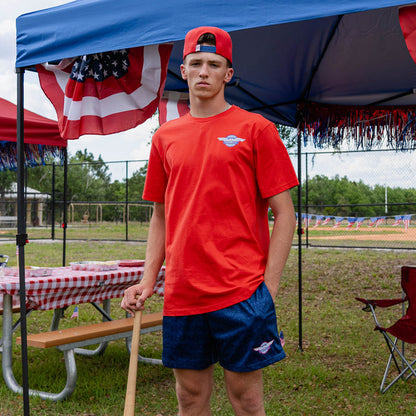 Adult model wearing navy shorts with “Fastball Flight” design