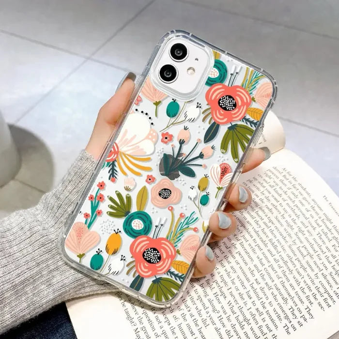 a woman holding a phone case with flowers on it