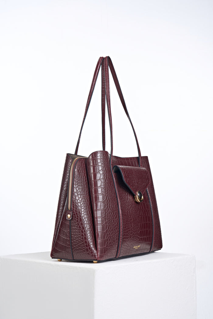 Side view of Francois Black Cherry Crocodile print faux leather Laptop Tote showing central zipper laptop compartment