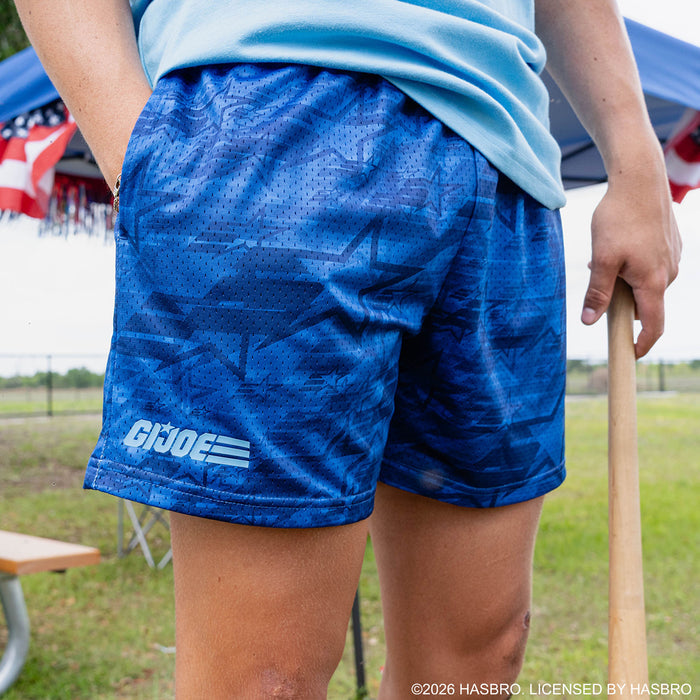 Adult model wearing blue shorts with “G.I. Joe Star” design