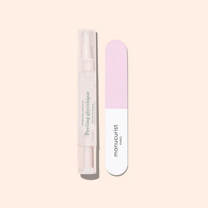 The Glossy Booster Duo by Manucurist—featuring a gentle nail exfoliator and a pink and white nail file—stands upright on a light beige background, perfect for achieving glossy nails.