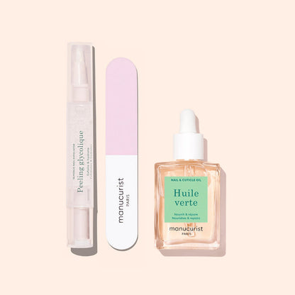 Three Glow Routine manicure essentials by Manucurist on a beige background: a clear peeling gel pen, a pink and white nail file, and a dropper bottle of cuticle oil for glossy nails and expert care.