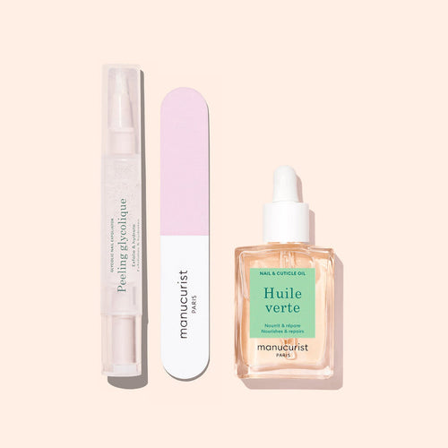 Three Glow Routine manicure essentials by Manucurist on a beige background: a clear peeling gel pen, a pink and white nail file, and a dropper bottle of cuticle oil for glossy nails and expert care.