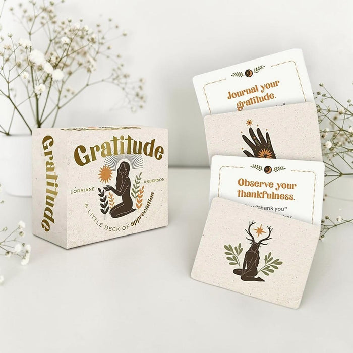 Gratitude card set with cards and packaging on a light surface with flowers in the background