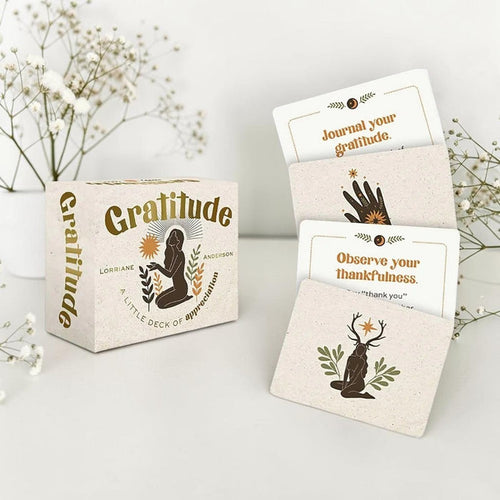 Gratitude card set with cards and packaging on a light surface with flowers in the background