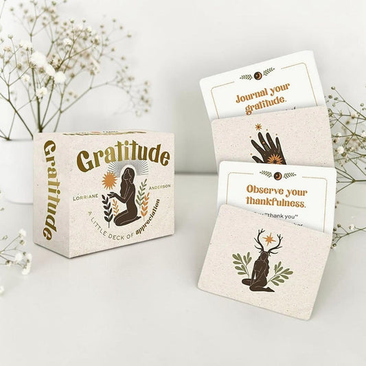 Gratitude card set with cards and packaging on a light surface with flowers in the background