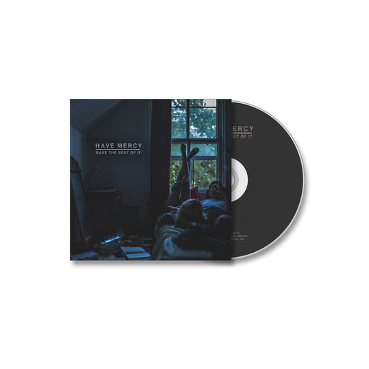 CD and case for Have Mercys Make The Best Of It, featuring cover art with a dimly lit room, a person on a bed by the window, and scattered items, reflecting the album’s mood for tracks like Smoke And Lace. Brand: Have Mercy.